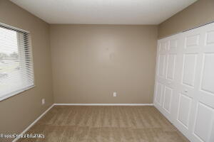 1021 Abada Court Northeast, Unit 102 Palm Bay, FL 32905 - Photo 16 of 16 a view of an empty room with a window