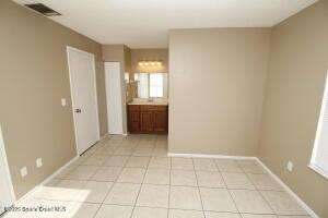 1021 Abada Court Northeast, Unit 102 Palm Bay, FL 32905 - Photo 10 of 16 a view of an empty room with windows