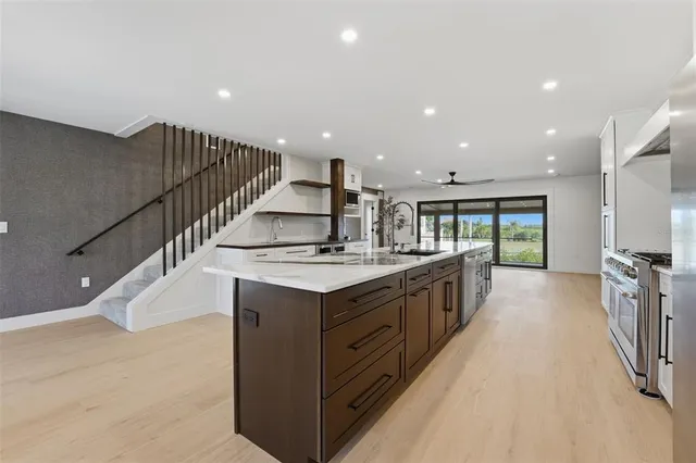 a view of a kitchen area with furniture and wooden floor