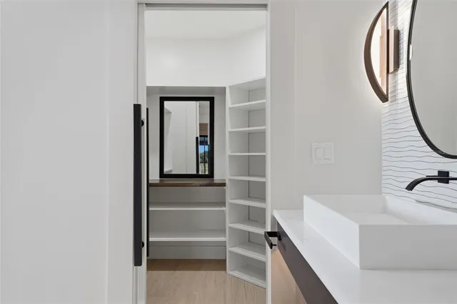 a spacious bathroom with a double vanity sink and a mirror