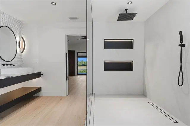 a bathroom with a glass shower door