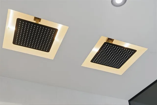 a bathroom with a double vanity sink mirror and shower