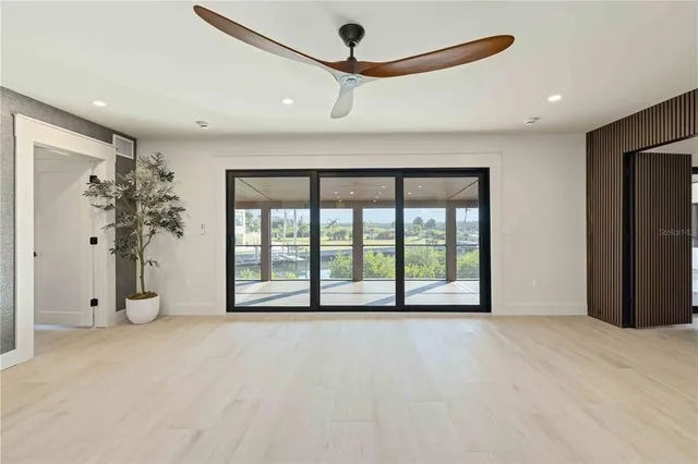 a living room with furniture kitchen view and a large window