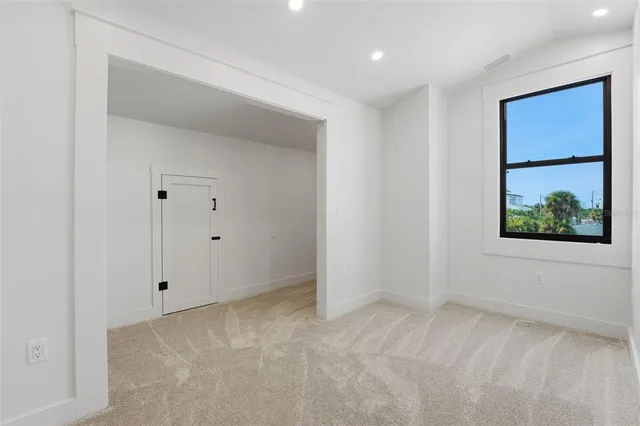 a view of house with a yard and potted plants