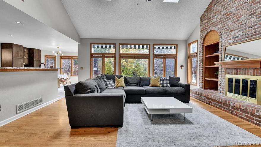 4852 South Carson Street Aurora, CO 80015 - Photo 12 of 48 a living room with furniture and large windows