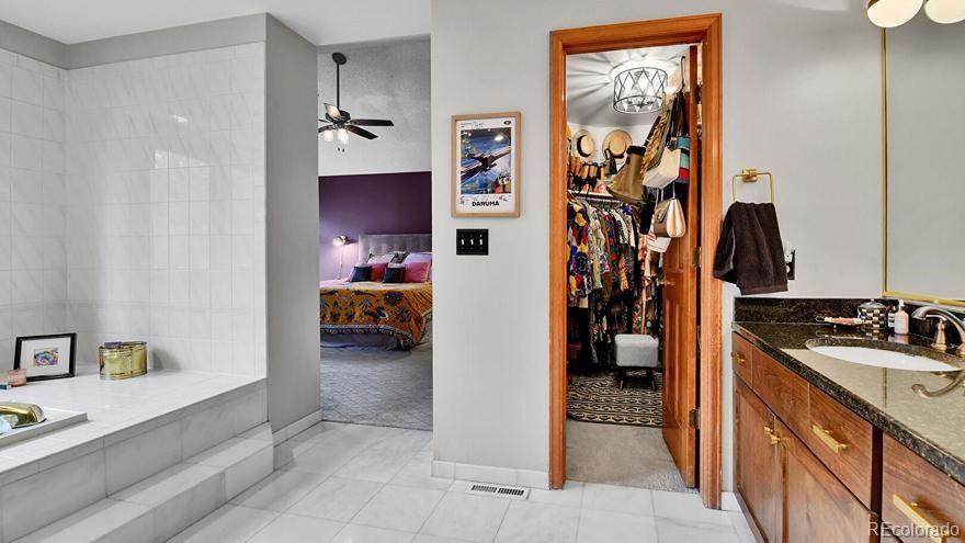 4852 South Carson Street Aurora, CO 80015 - Photo 27 of 48 a view of a hallway with closet and a bedroom