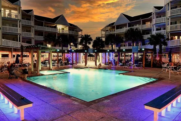 a view of a swimming pool with a lawn chairs and a yard