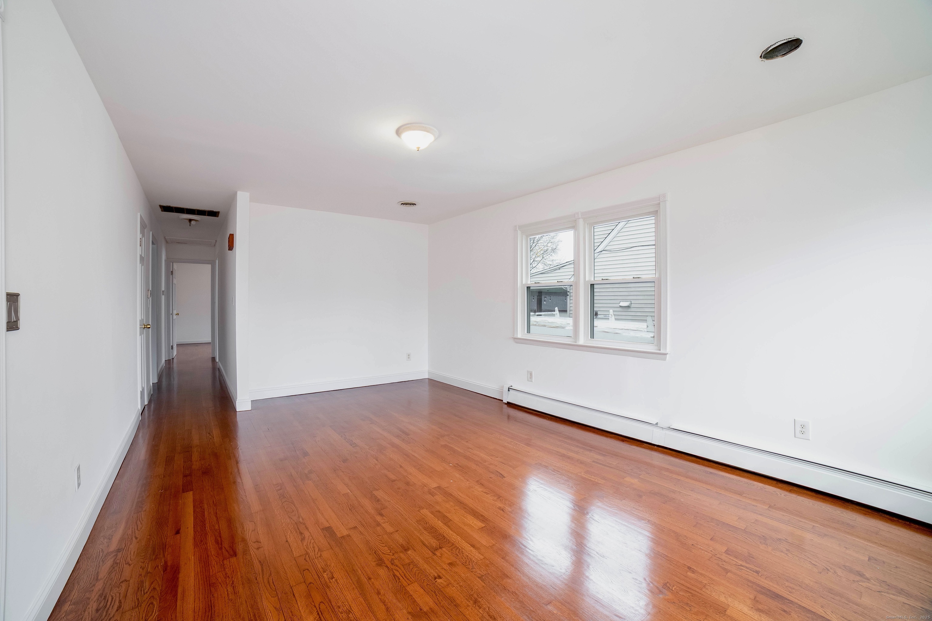 45 Voight Avenue Bridgeport, CT 06606 - Photo 14 of 27 an empty room with wooden floor and windows
