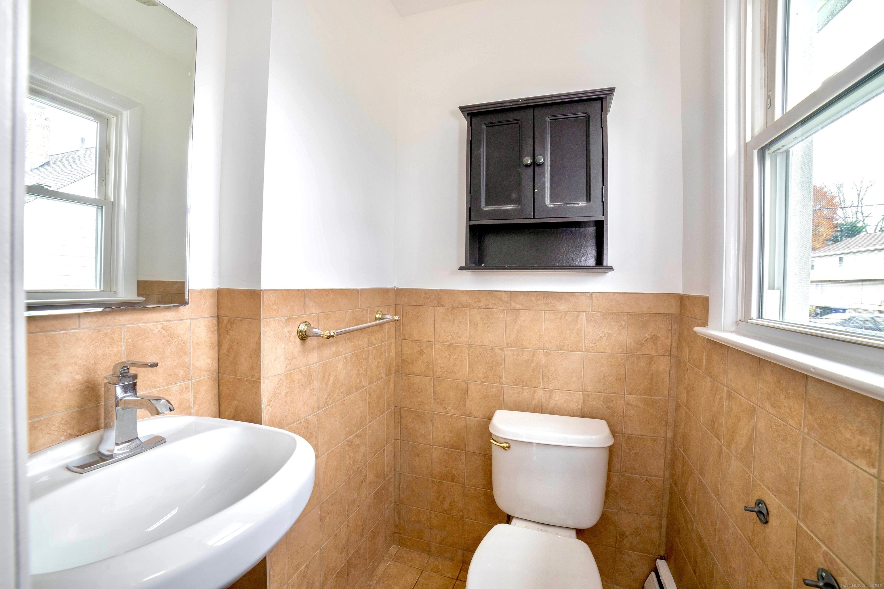 45 Voight Avenue Bridgeport, CT 06606 - Photo 18 of 27 a bathroom with a toilet sink and mirror