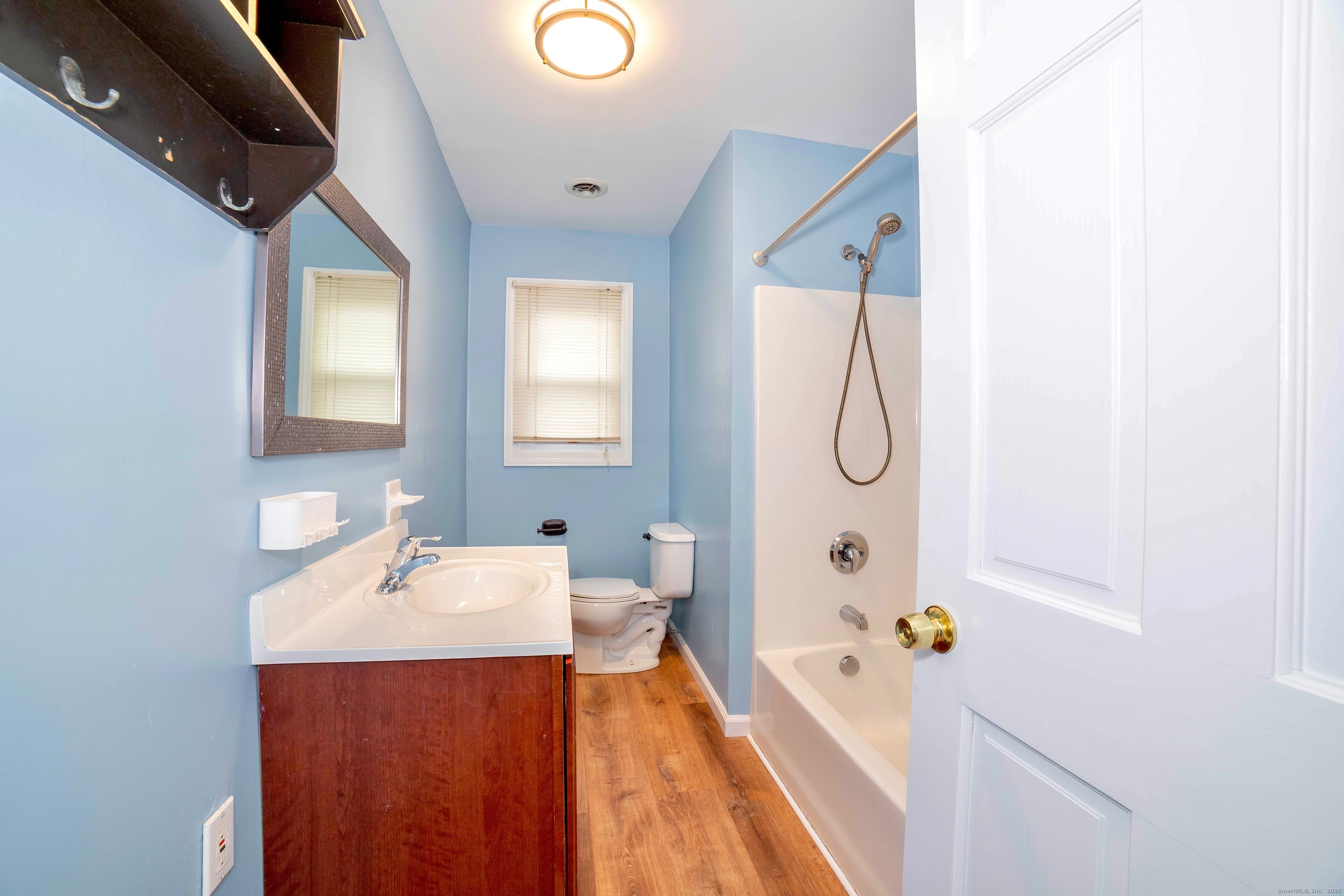 45 Voight Avenue Bridgeport, CT 06606 - Photo 21 of 27 a bathroom with a tub sink and mirror