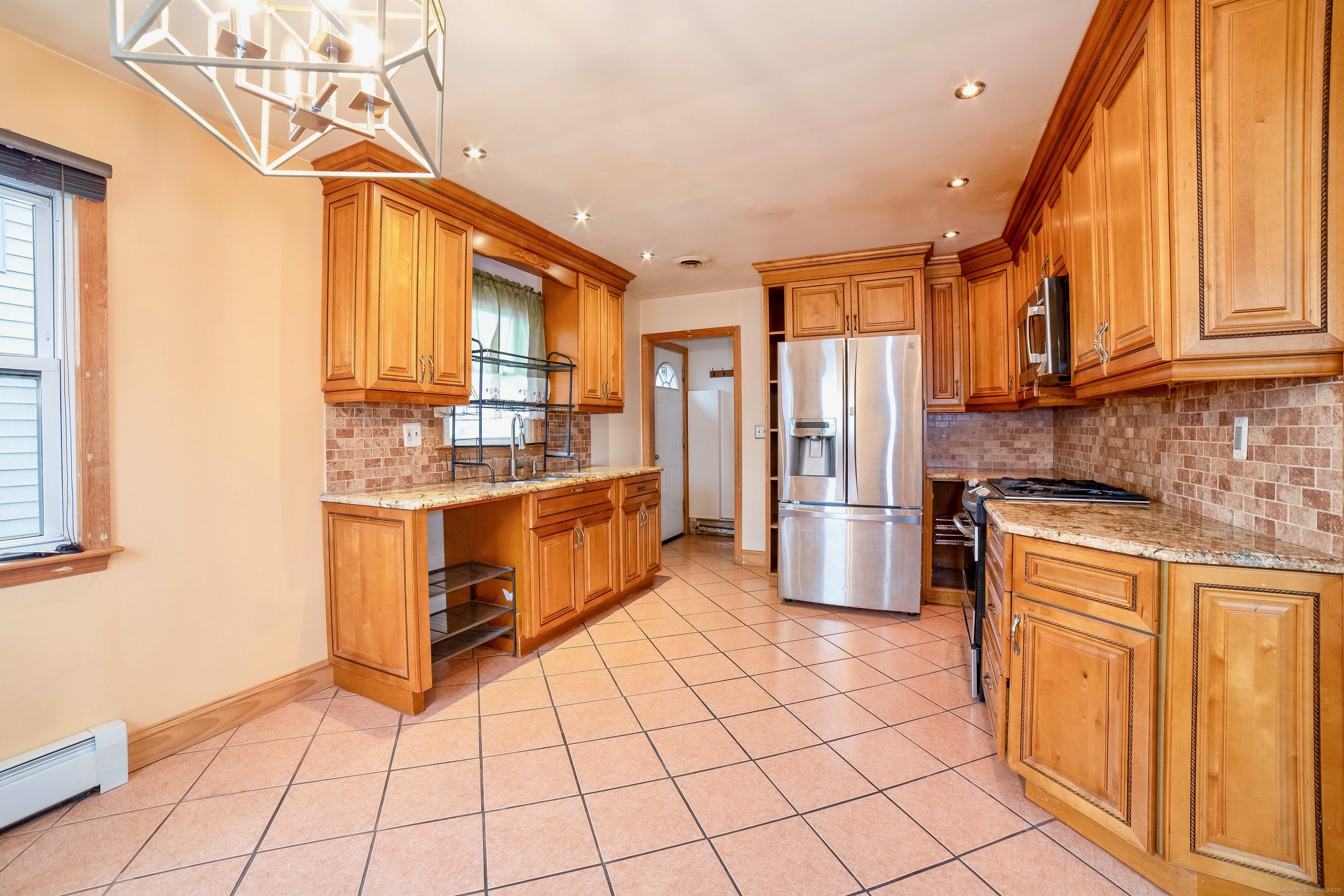 45 Voight Avenue Bridgeport, CT 06606 - Photo 7 of 27 a kitchen with stainless steel appliances cabinets a sink and a window
