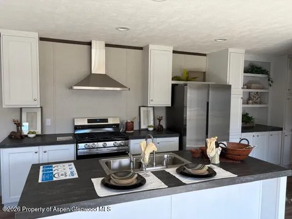 a kitchen with a sink a stove and a refrigerator