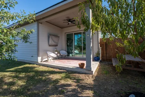 a view of a swimming pool with lounge chairs in patio