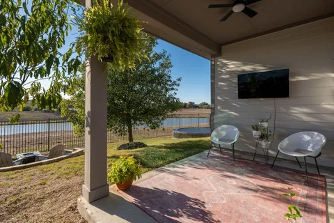 a view of a house with backyard porch and sitting area