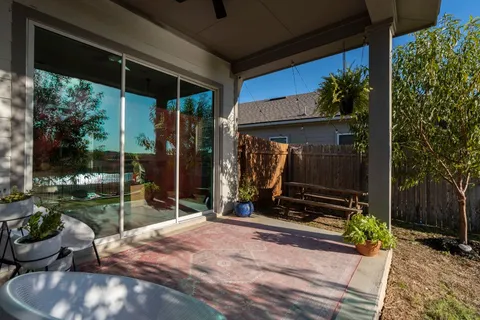 a backyard of a house with table and chairs