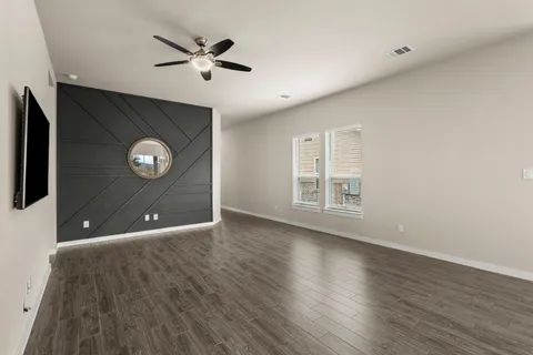 a kitchen with kitchen island a sink and a stove with wooden floor