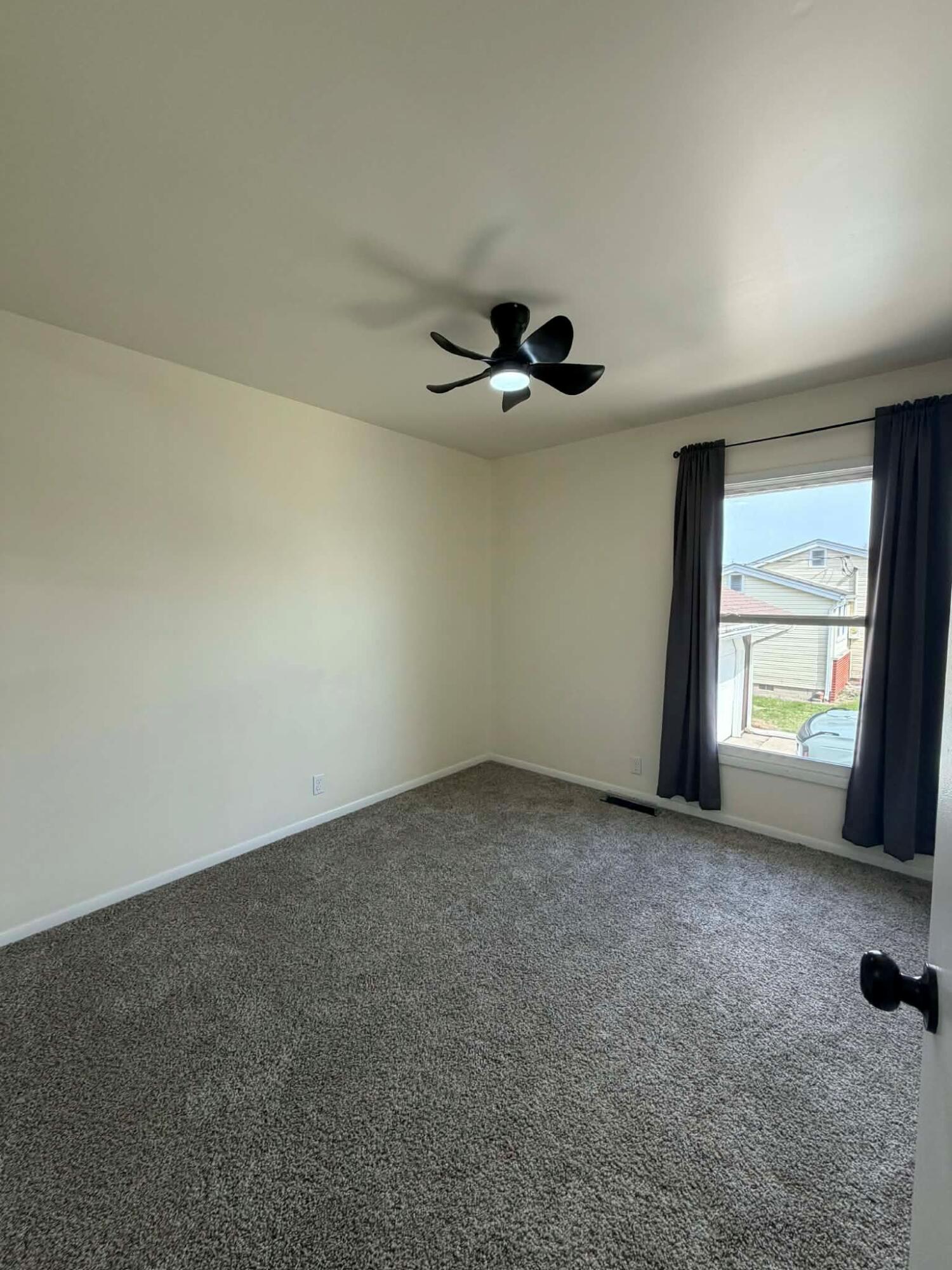 716 East Stewart Drive Rensselaer, IN 47978 - Photo 13 of 22 an empty room with a window and a ceiling fan