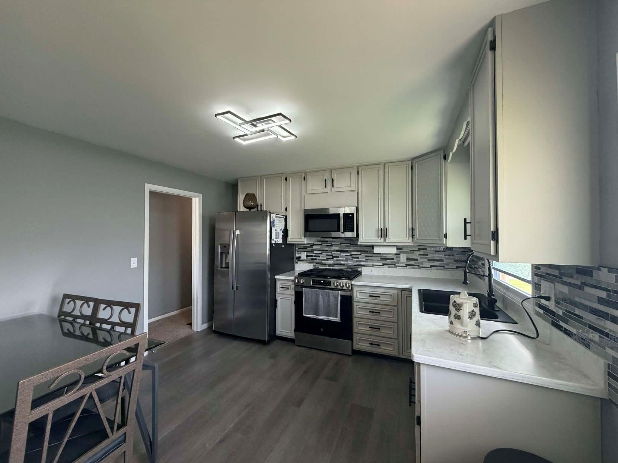 716 East Stewart Drive Rensselaer, IN 47978 - Photo 6 of 22 a kitchen with a stove and a refrigerator