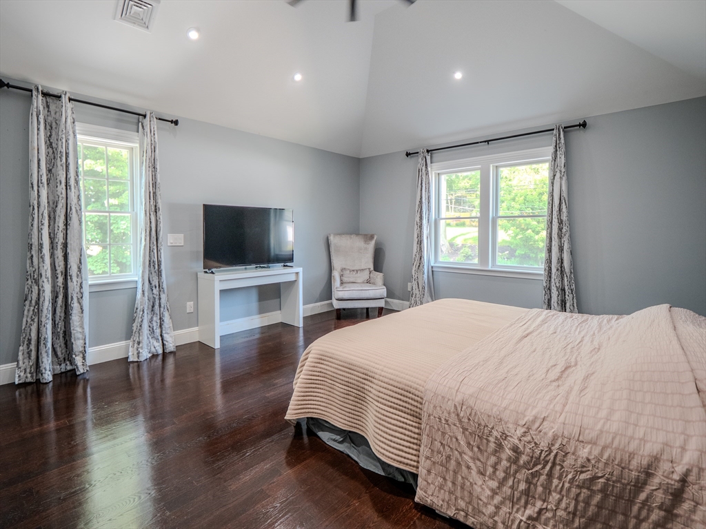 159 Mishawum Road Woburn, MA 01801 - Photo 20 of 41 a bedroom with a bed and a flat screen tv