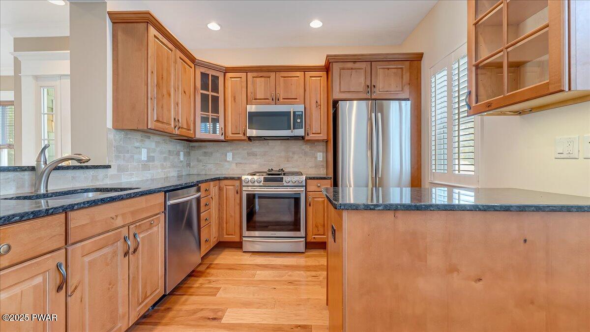 1010 MacIntosh Way Matamoras, PA 18336 - Photo 20 of 60 a kitchen with stainless steel appliances granite countertop a stove a sink and a refrigerator