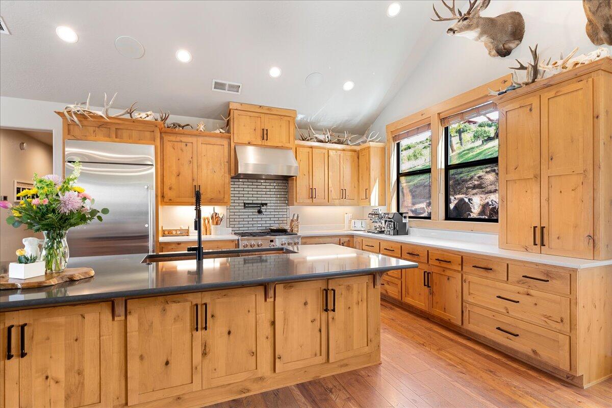 2220 Butte Falls Highway Eagle Point, OR 97524 - Photo 16 of 69 a kitchen with kitchen island granite countertop a sink appliances cabinets and a counter top space