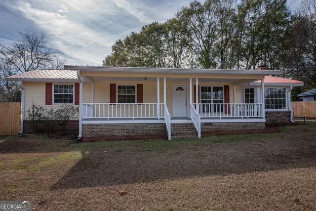 a house with trees in the background