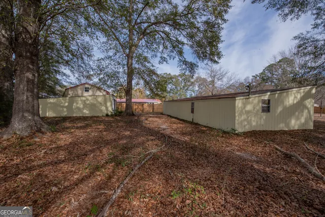 a view of backyard with large trees