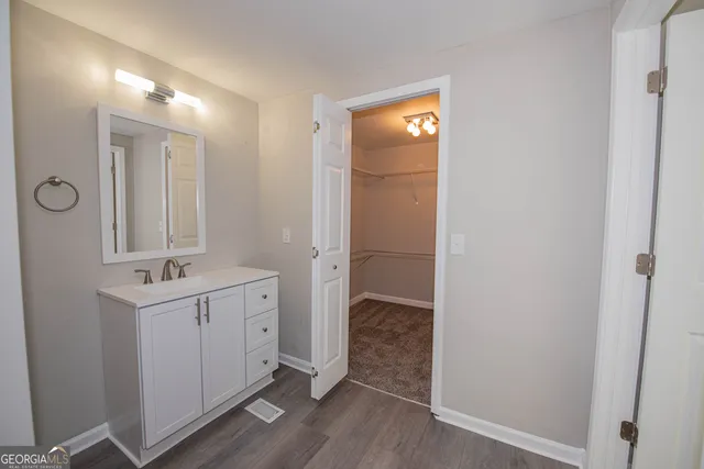 a bathroom with a sink a mirror and a shower