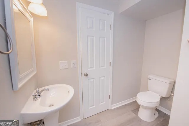 a bathroom with a toilet sink and shower