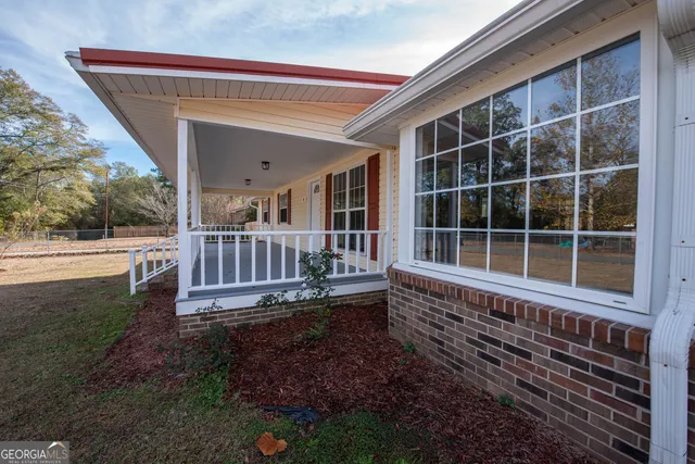 a view of a house with a backyard