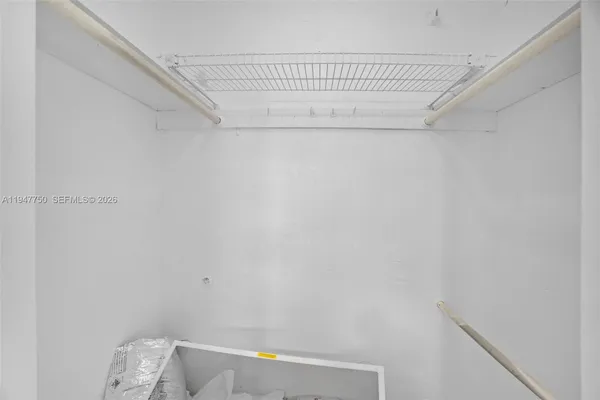 a bathroom with a small white wall and a shower