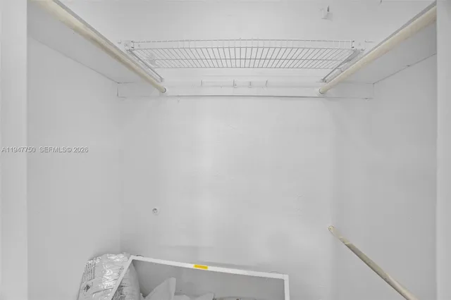 a bathroom with a small white wall and a shower