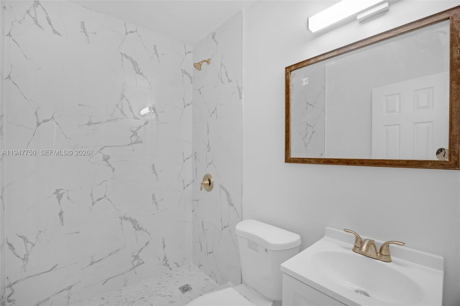 2530 Southwest 16th Terrace, Unit 1 Miami, FL 33145 - Photo 16 of 48 a white toilet sitting next to a bathroom sink