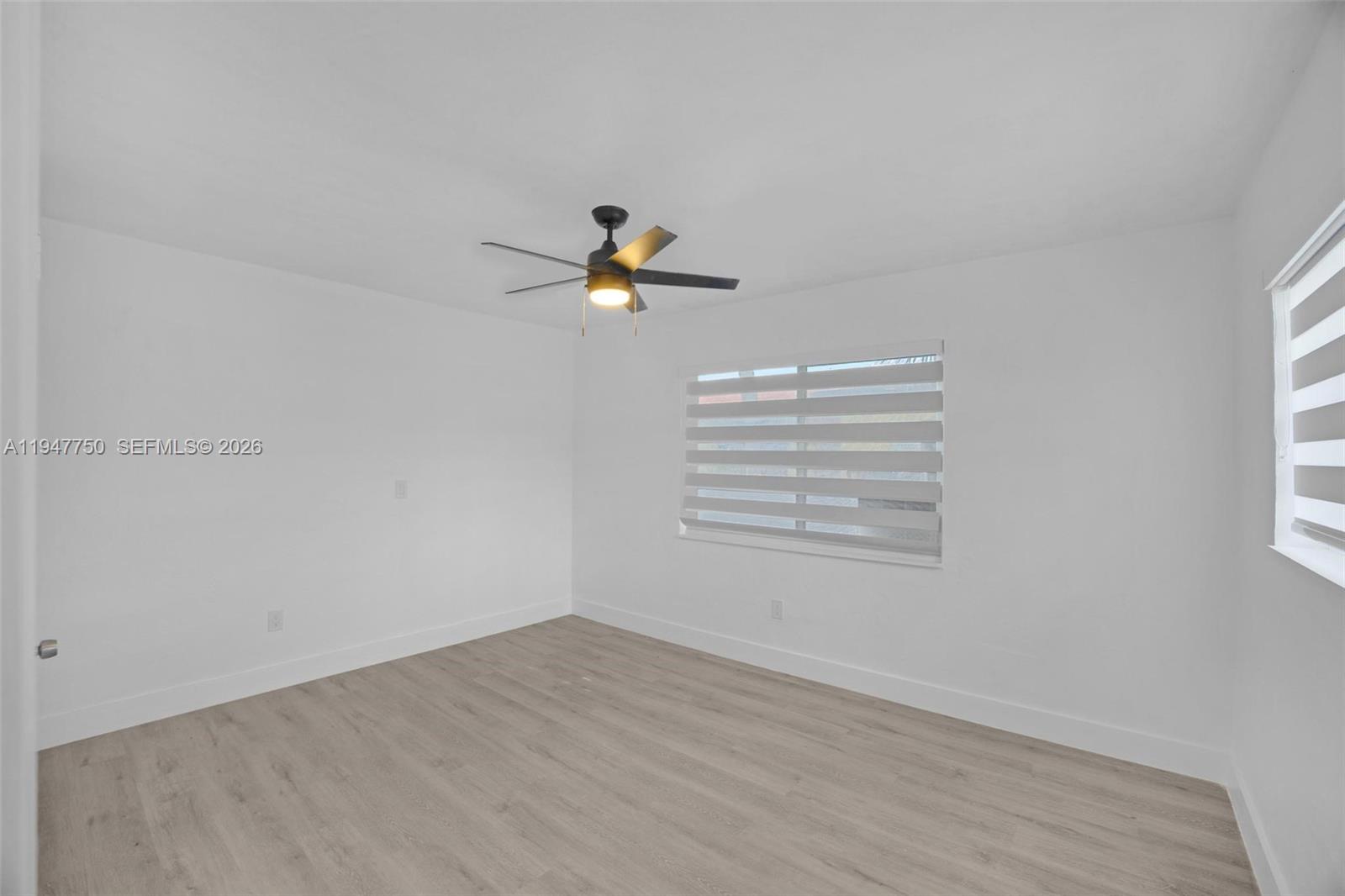 2530 Southwest 16th Terrace, Unit 1 Miami, FL 33145 - Photo 17 of 48 a view of empty room with wooden floor and fan