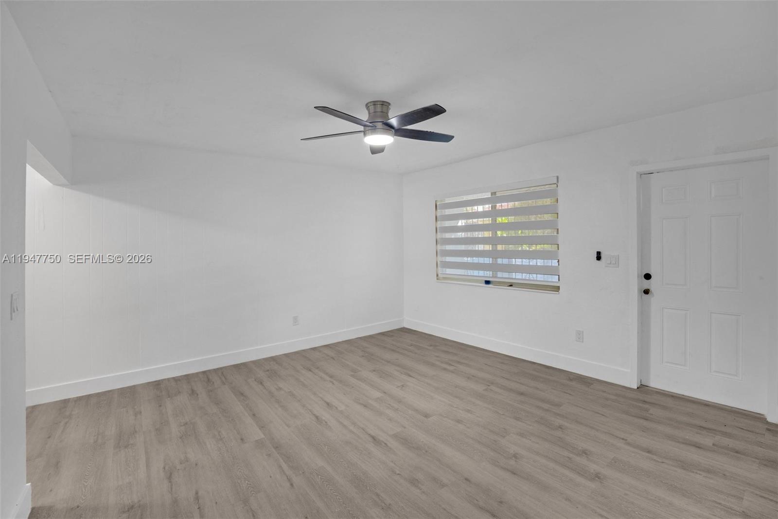 2530 Southwest 16th Terrace, Unit 1 Miami, FL 33145 - Photo 21 of 48 an empty room with wooden floor ceiling fan and windows