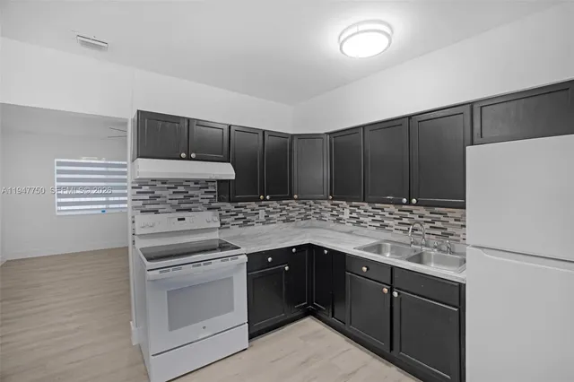 a kitchen with a refrigerator and a stove