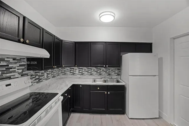 a kitchen with a stove and a refrigerator