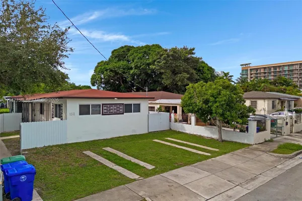 a front view of a house with a garden