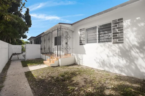 a view of a backyard with a wooden fence