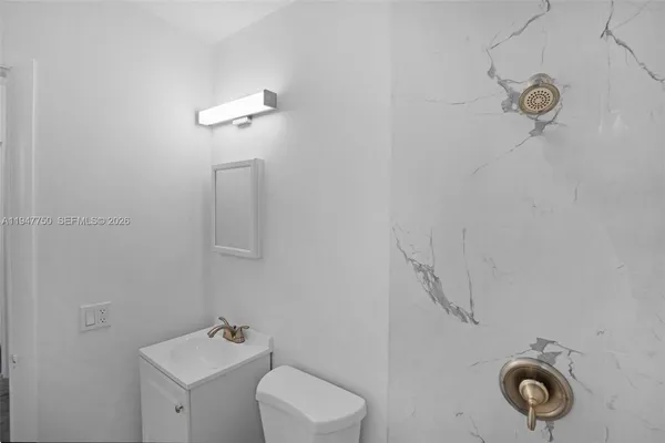 a bathroom with a toilet sink and shower