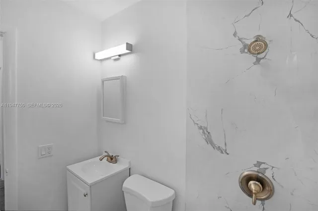 a bathroom with a toilet sink and shower