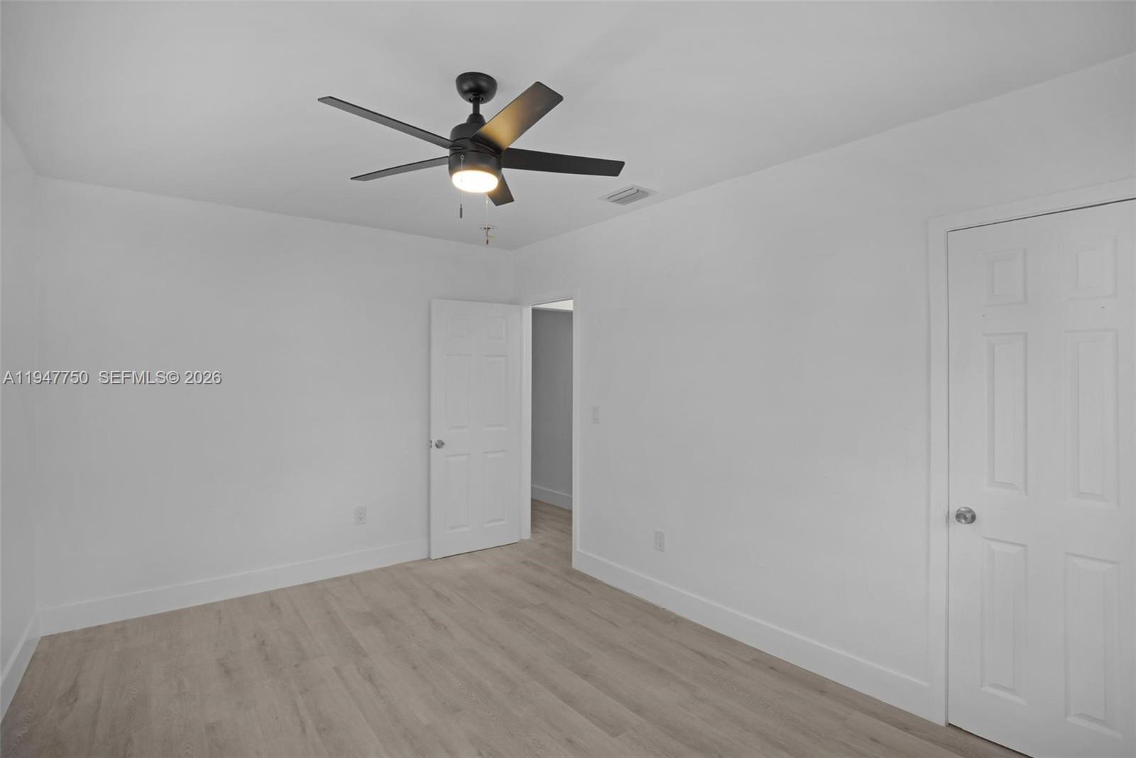 2530 Southwest 16th Terrace, Unit 1 Miami, FL 33145 - Photo 39 of 48 a view of a big room with wooden floor closet and windows in a room