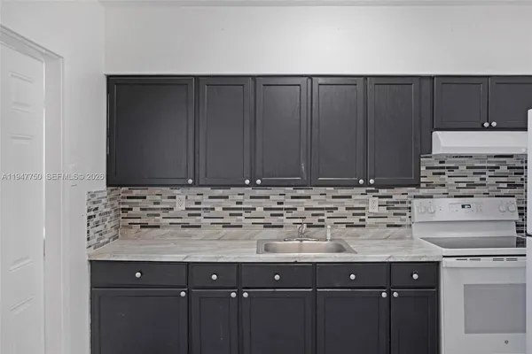 a kitchen with stainless steel appliances a stove and a refrigerator