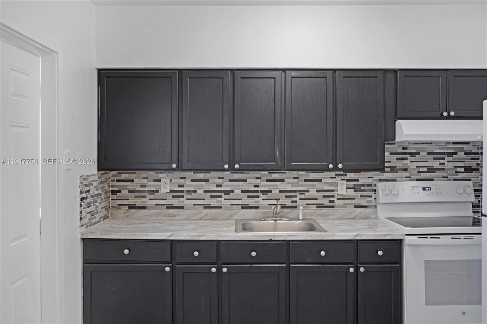 2530 Southwest 16th Terrace, Unit 1 Miami, FL 33145 - Photo 42 of 48 a bathroom with a sink and cabinets