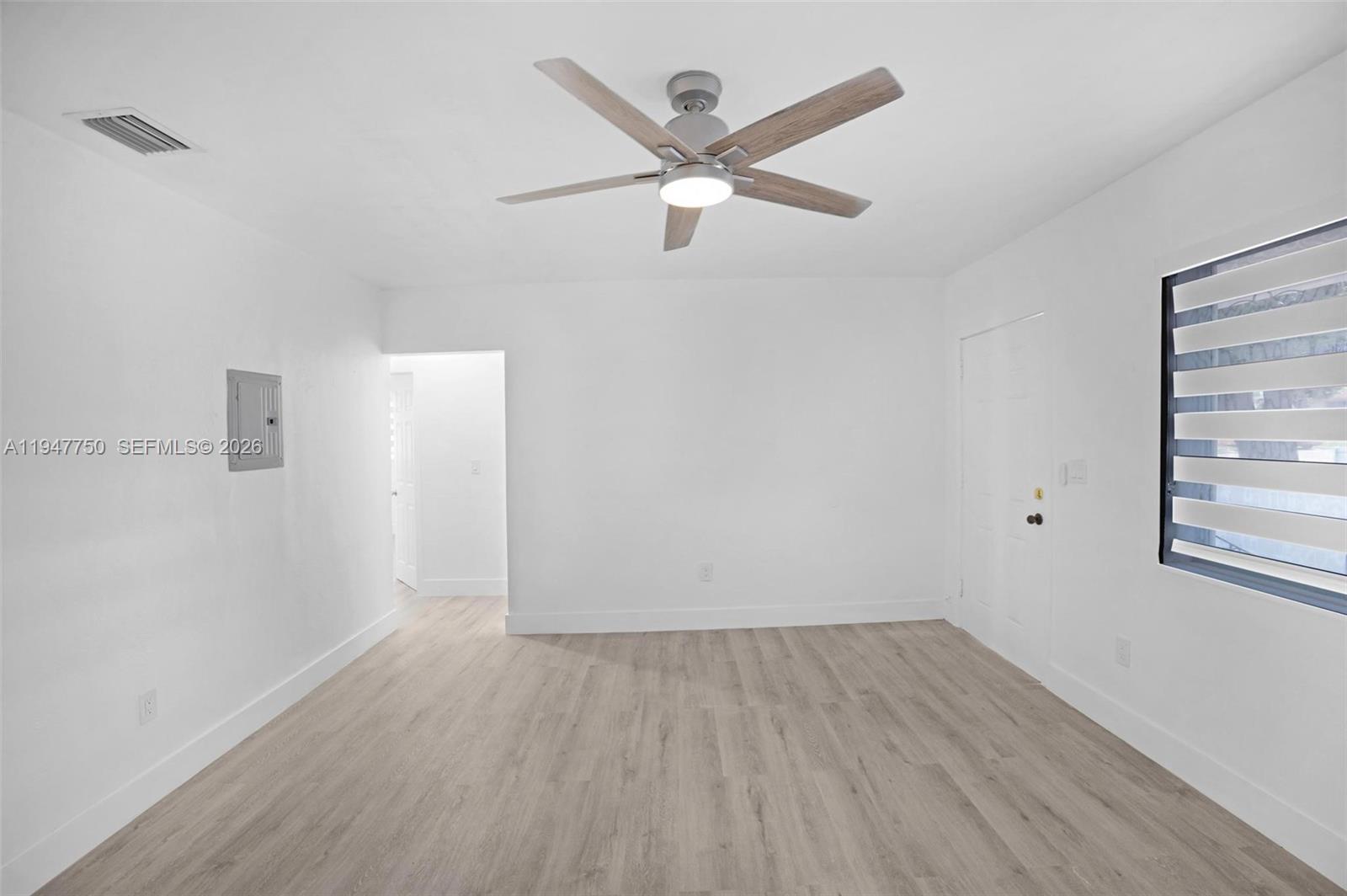 2530 Southwest 16th Terrace, Unit 1 Miami, FL 33145 - Photo 46 of 48 an empty room with wooden floor and windows