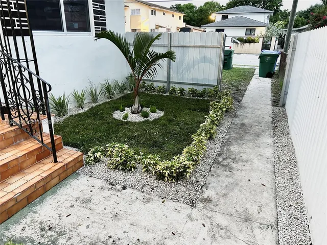 a view of a yard with table and chairs