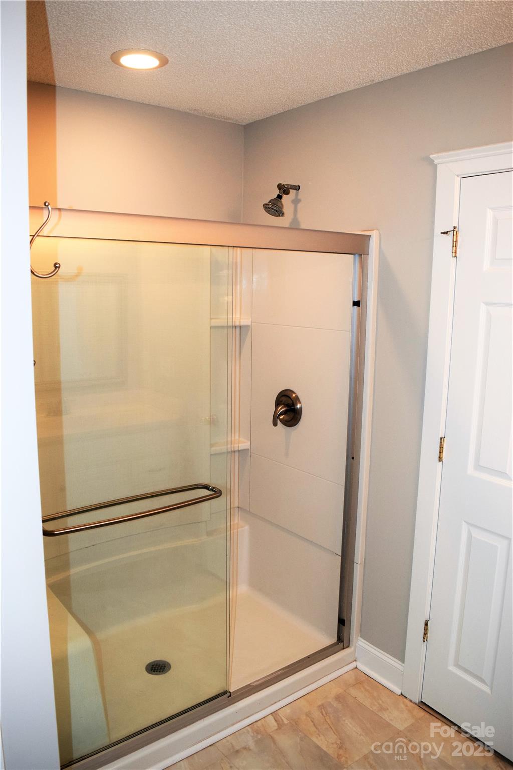 13840 Hastings Farm Road Huntersville, NC 28078 - Photo 27 of 32 a bathroom with a glass shower door