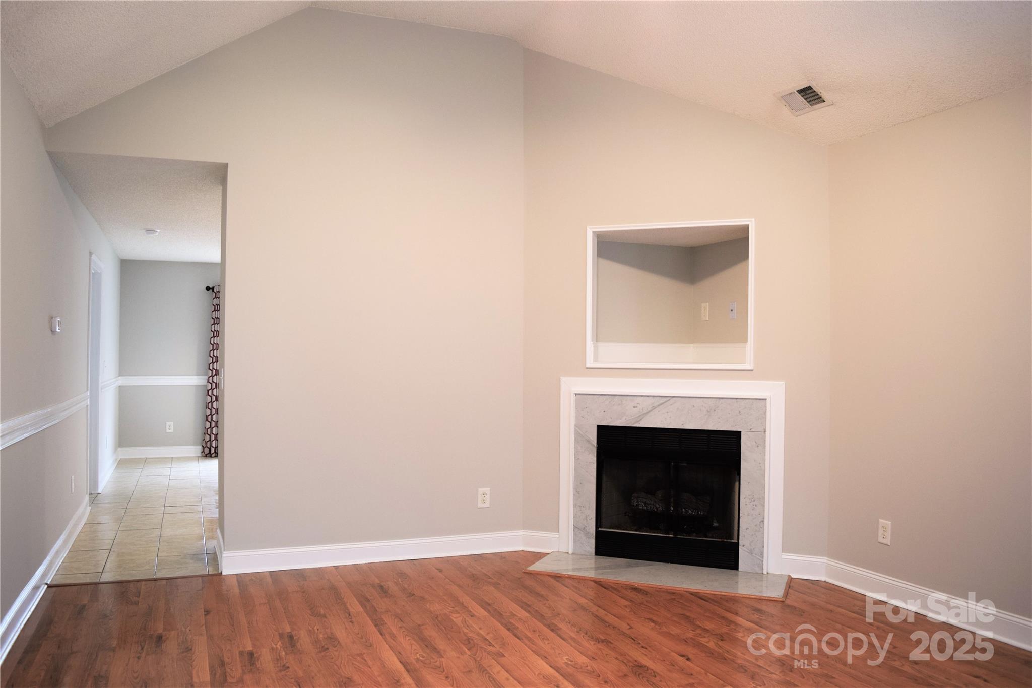13840 Hastings Farm Road Huntersville, NC 28078 - Photo 4 of 32 a view of an empty room with wooden floor and a window