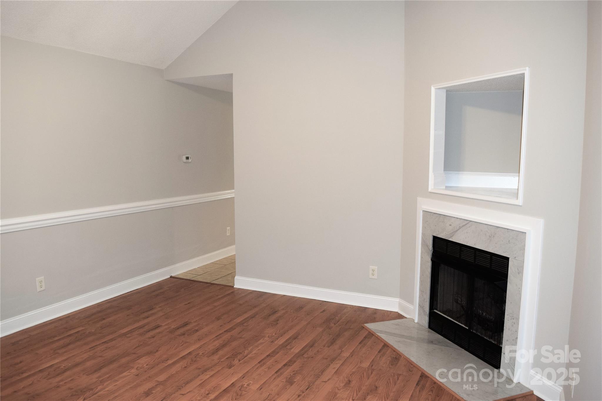 13840 Hastings Farm Road Huntersville, NC 28078 - Photo 5 of 32 a view of a livingroom with wooden floor and a fireplace