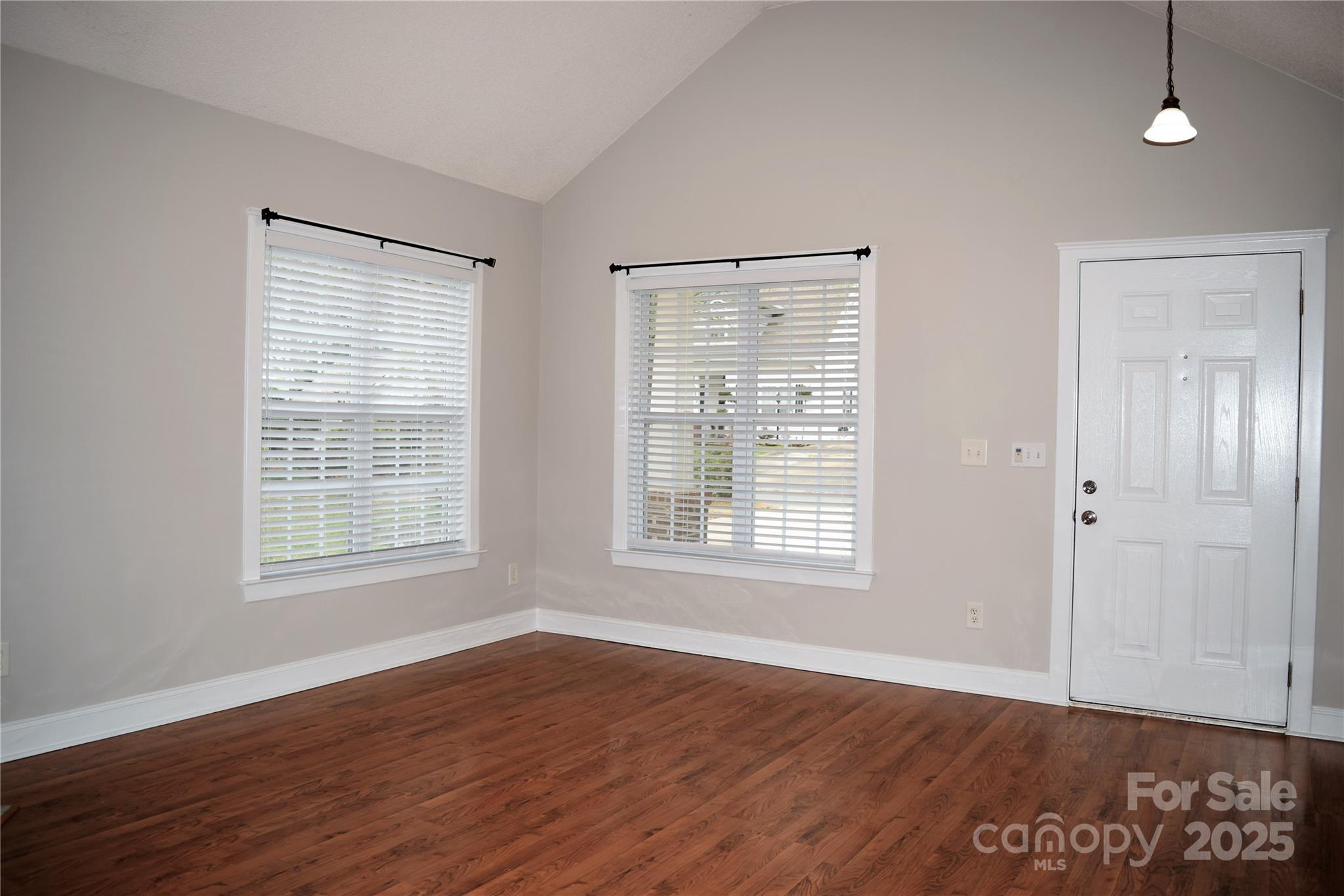 13840 Hastings Farm Road Huntersville, NC 28078 - Photo 6 of 32 a view of an empty room with wooden floor and a window